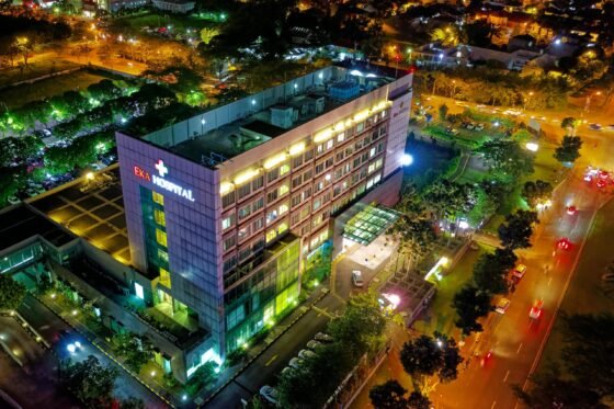 Stunning aerial view of Eka Hospital in Serpong, Indonesia, illuminated at night, capturing vibrant city lights and architecture.