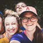 A joyful group of women taking a selfie outdoors, showcasing happiness and friendship.